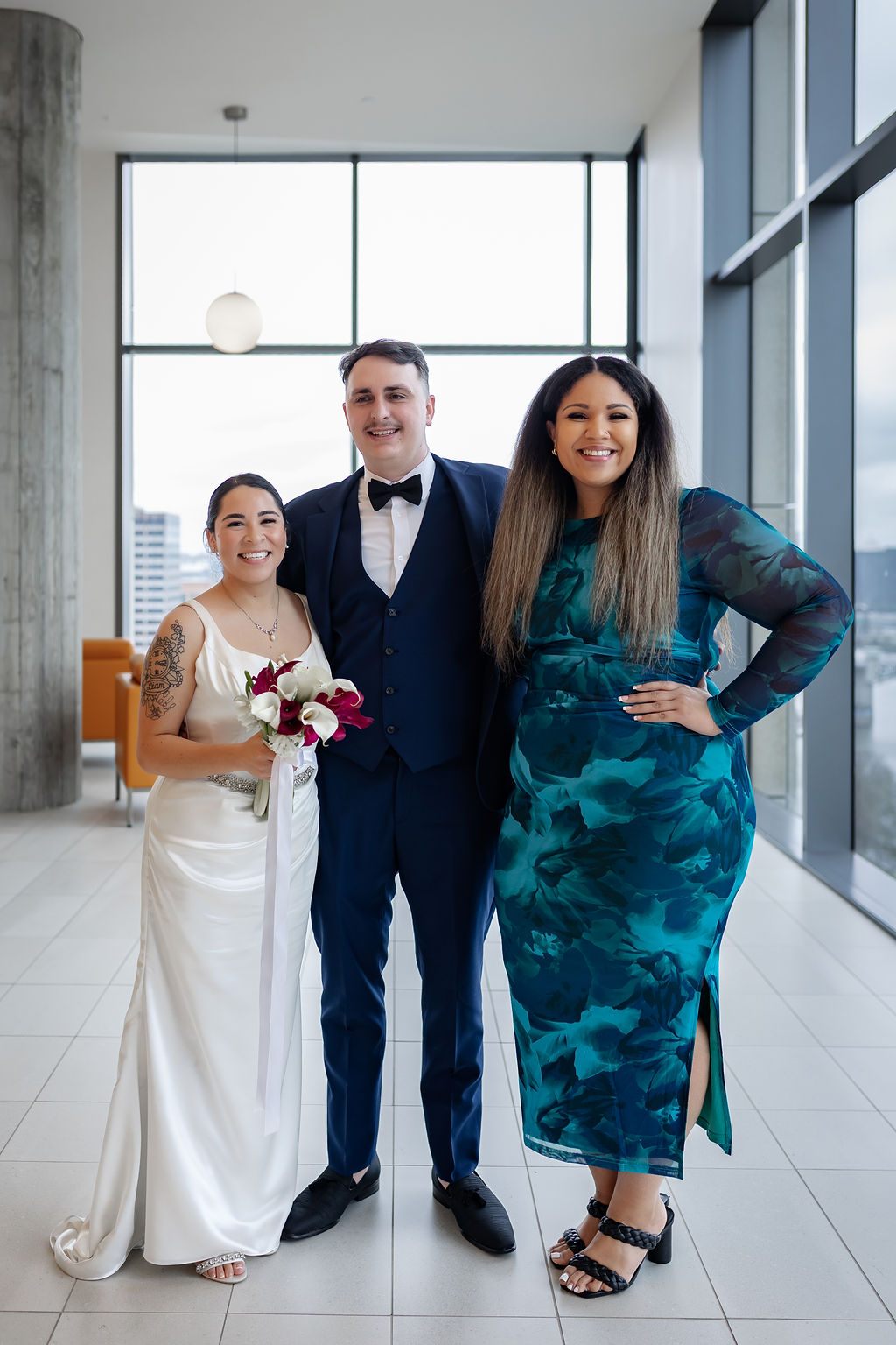 Bella with a bride and groom at their downtown wedding